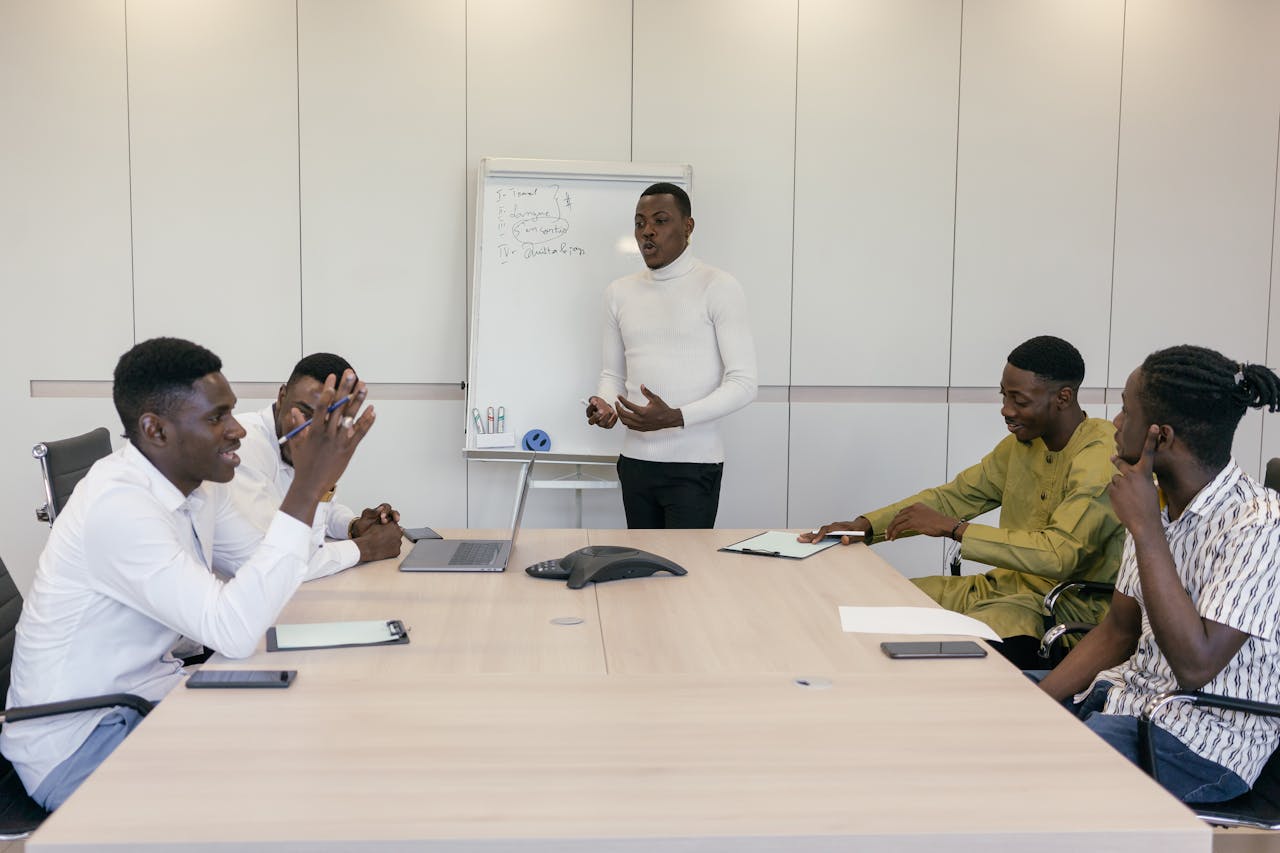A group of professionals engaged in a business meeting in an office setting.